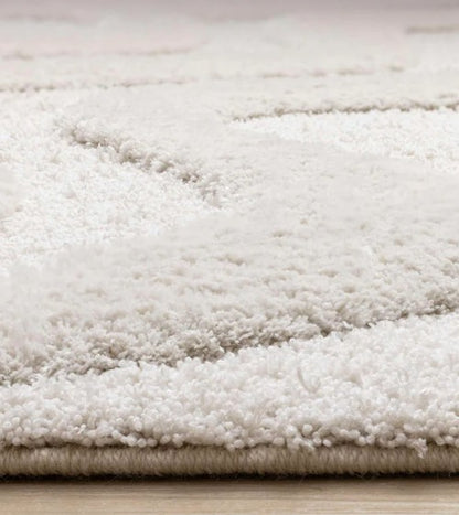 Close-up of a textured white rug on a wooden floor