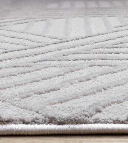 Close-up of a textured gray rug on a wooden floor