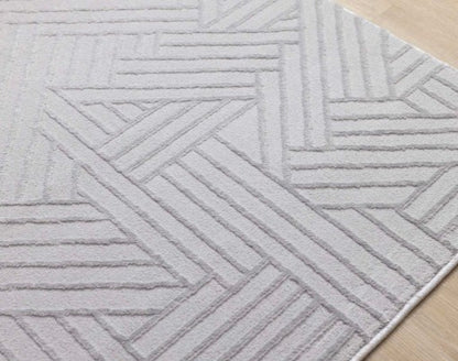 Gray geometric patterned rug on a wooden floor