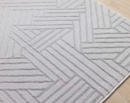 Gray geometric patterned rug on a wooden floor