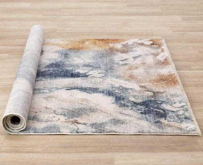 Roll of abstract patterned rug on a wooden floor
