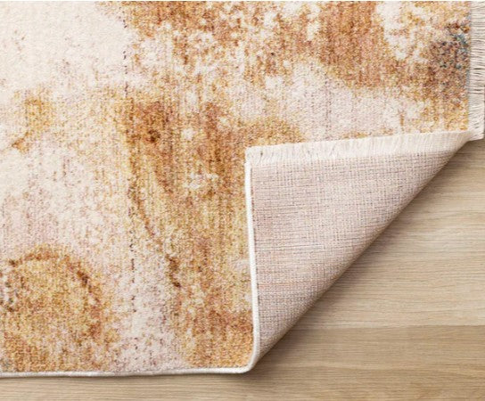 Textured area rug with a mix of brown and beige colors on a wooden floor.
