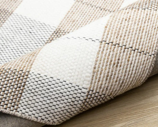 Close-up of a textured fabric with a checkered pattern on a wooden surface