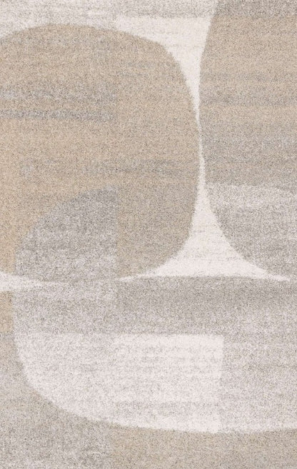 Close-up of a textured rug with abstract shapes in beige, brown, and white.