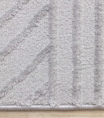 Close-up of a textured gray rug on a wooden floor
