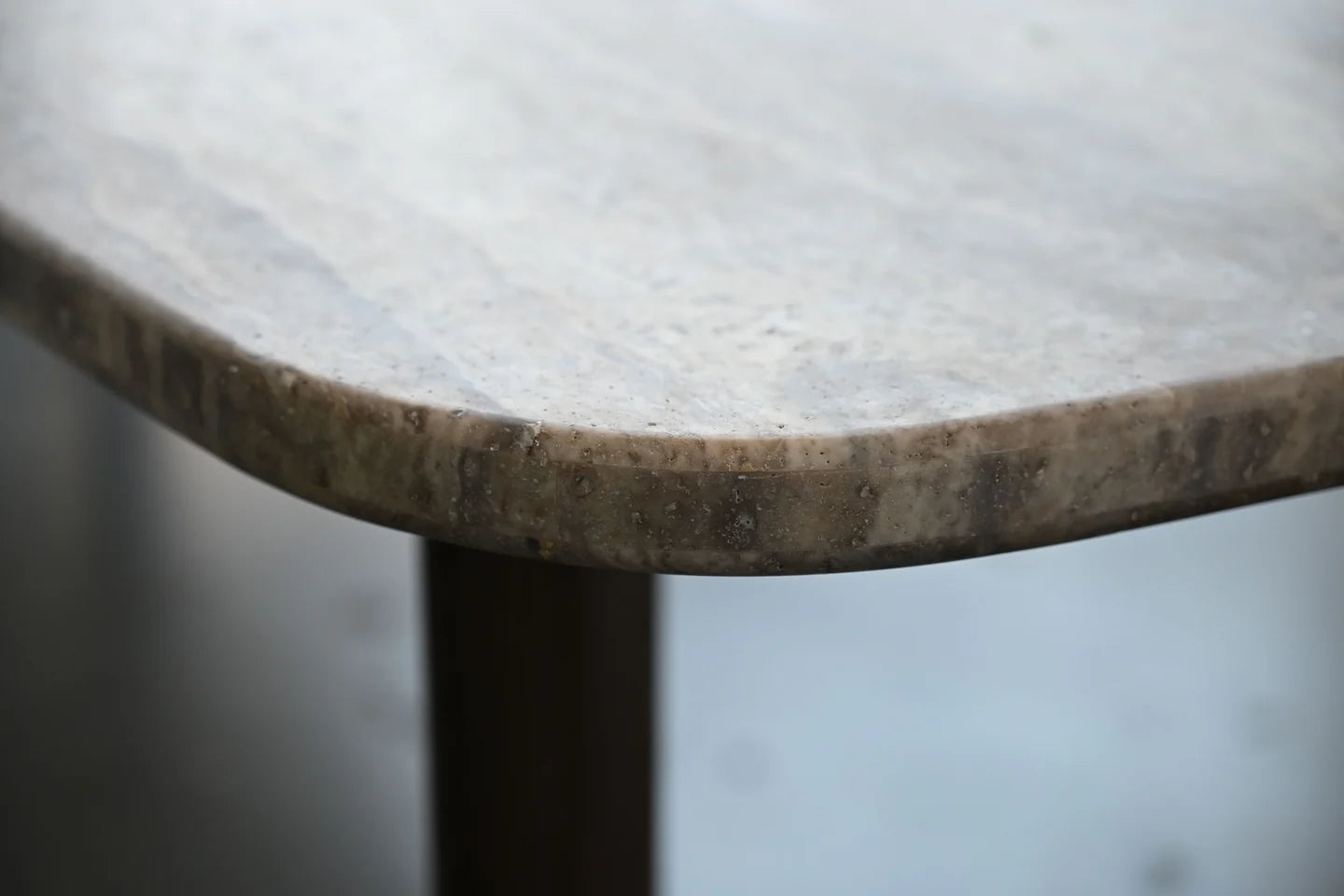 Close-up of a round marble table with a blurred background