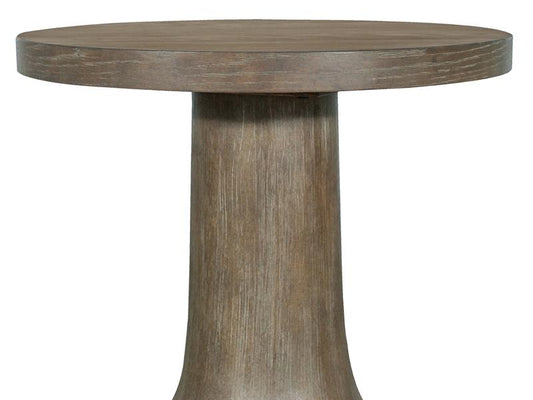 Round wooden table with a thick cylindrical base on a white background