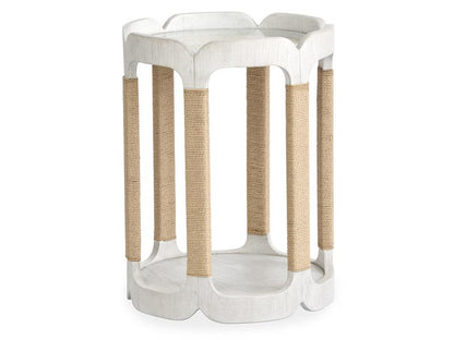White side table with woven brown legs on a white background