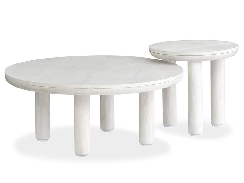 Two white round tables with white washed finish on a white background