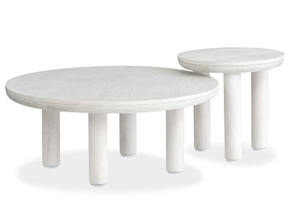 Two white round tables with white washed finish on a white background