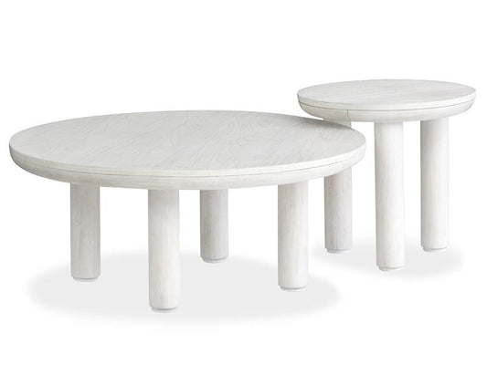 Two white round tables with white washed finish on a white background