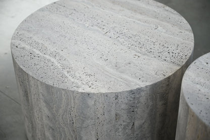 Marble cylindrical stool on a neutral background