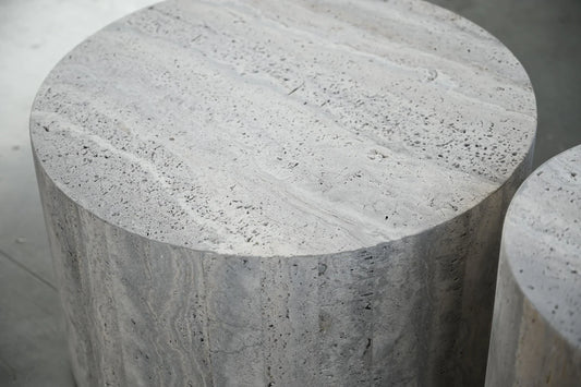 Marble cylindrical stool on a neutral background