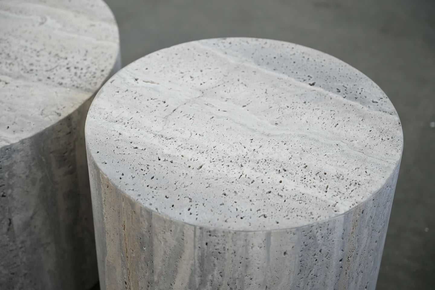 Close-up of a concrete cylindrical object with a textured surface.