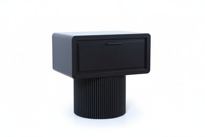 Modern black and gray side table with a drawer on a light wood floor.