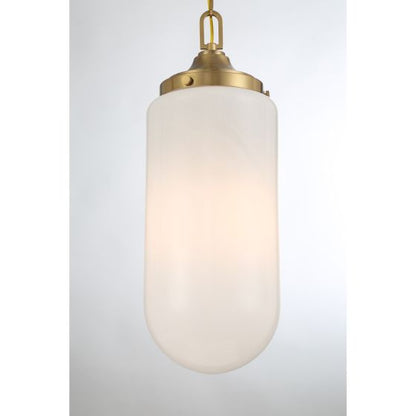 Pendant light with white glass shade and brass fixture on a light gray background