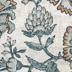 Close-up of floral patterned fabric with blue, brown, and beige colors.