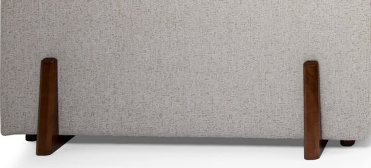 Gray upholstered bench with wooden legs on a white background