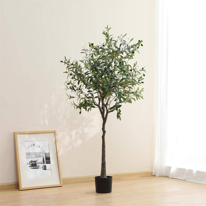 Potted artificial olive tree in a room with a framed picture on the wall.