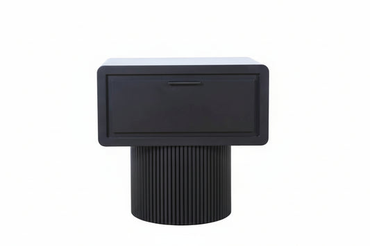 Black side table with a textured cylindrical base on a light wood floor.