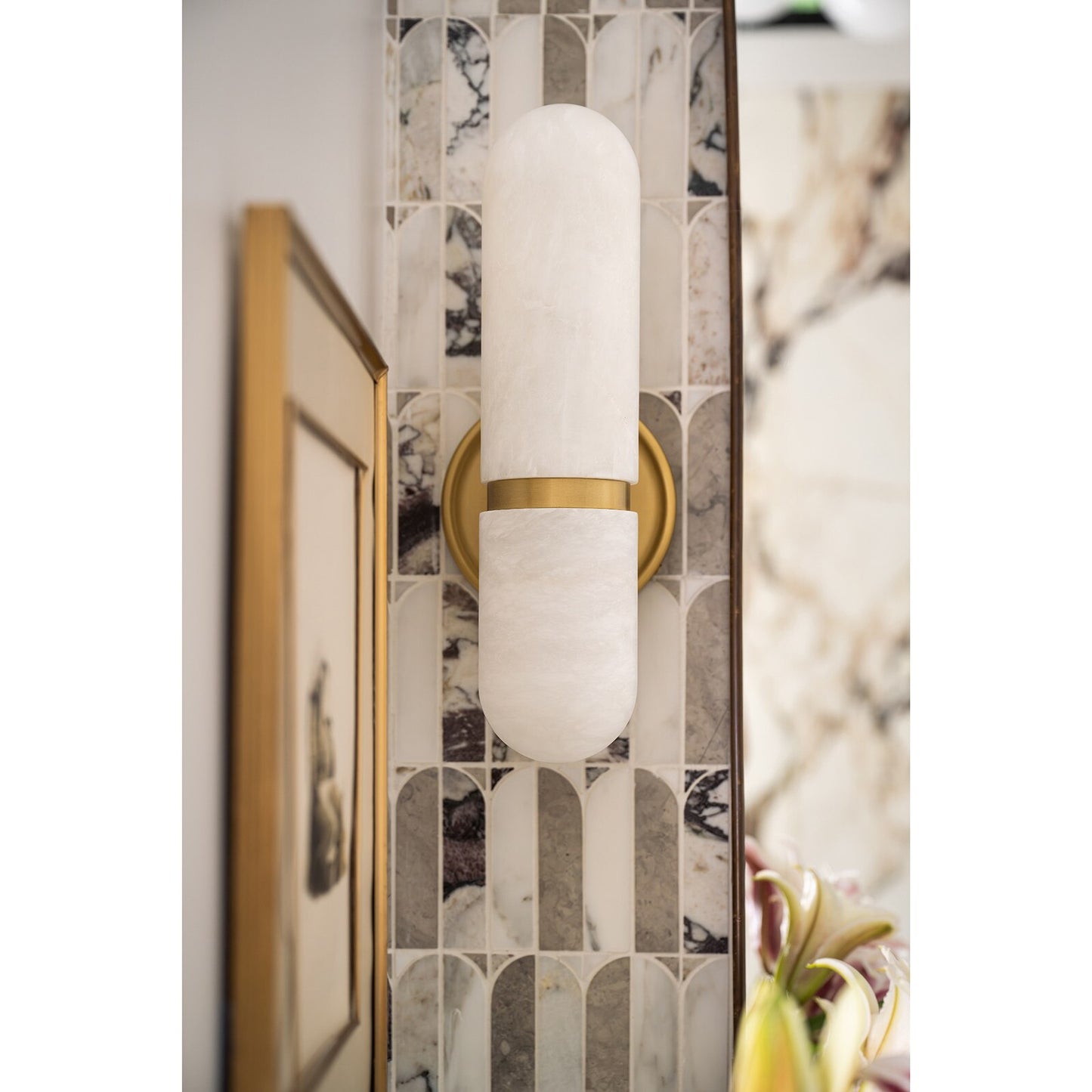 Wall sconce with gold and white design in a decorative setting