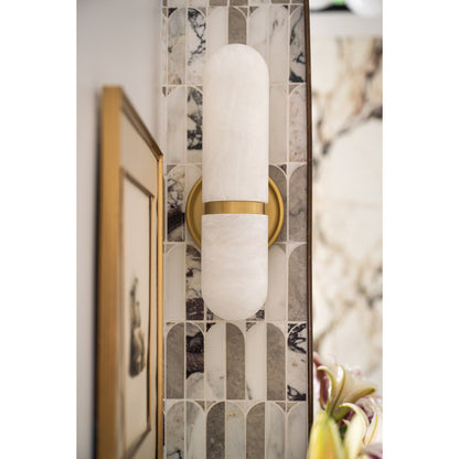 Wall sconce with gold and white design in a decorative setting