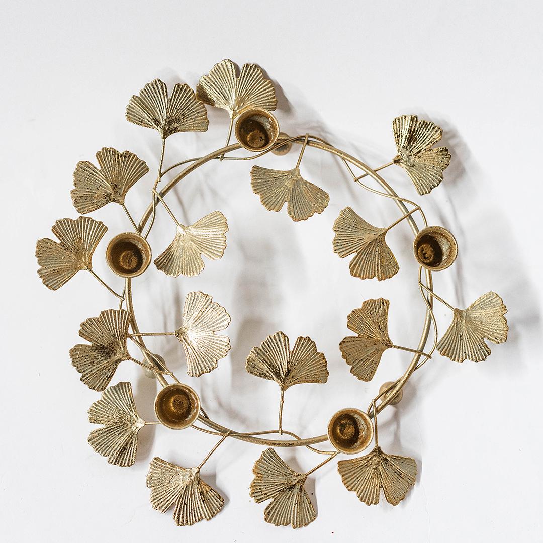 Decorative wall piece with gold leaf design on a white background