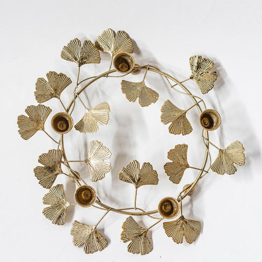 Decorative wall piece with gold leaf design on a white background