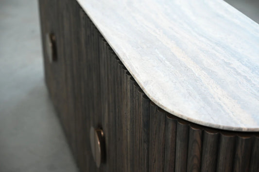 Wooden sideboard with marble countertop on a gray floor