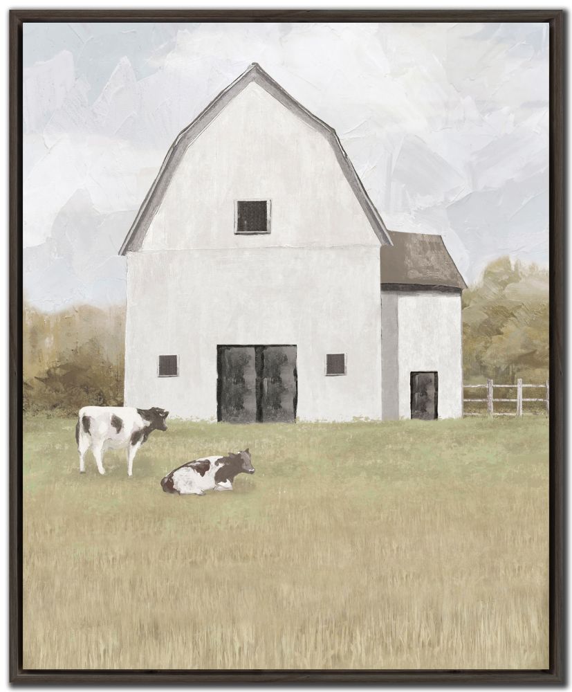 Framed artwork of a white barn with two cows in a field