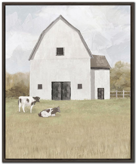 Framed artwork of a white barn with two cows in a field