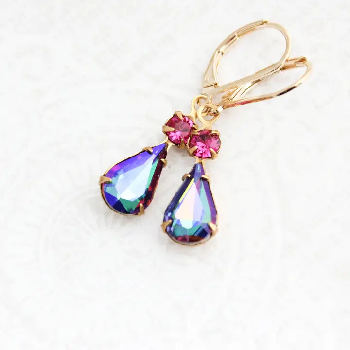 Gold earrings with colorful teardrop-shaped gemstones on a white background
